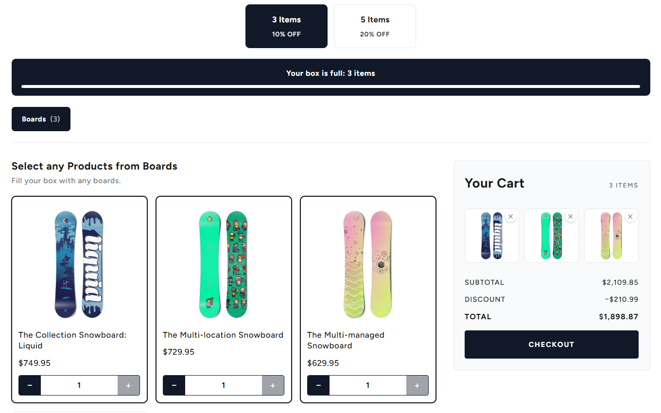 The Snow Box builder with three boards picked, each with a quantity stepper. The bar reads Your box is full: 3 items, and the box cart shows the three boards in its slots with a subtotal, a discount line, a total and a Checkout button